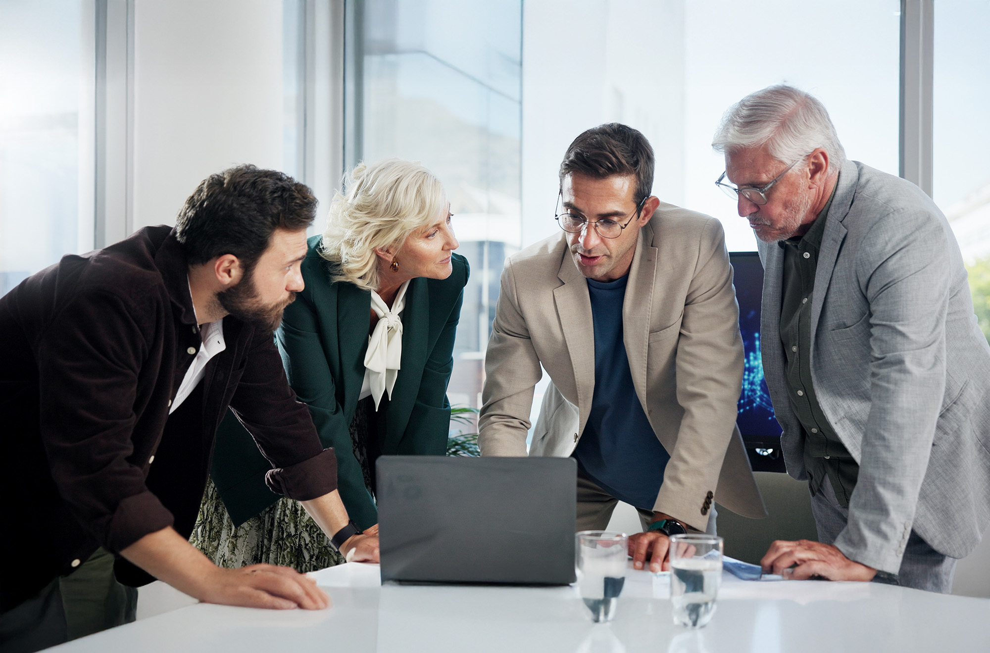 Collaboration, colleagues and group with laptop, planning and review of economic trends on website. Teamwork, reading and discussion for investment in company, financial analyst and tech for project